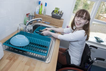 Student washing up in her flat
